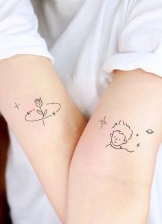 two small tattoos on the arms of people with stars and planets behind them, one has a child's face