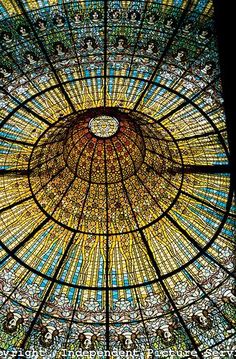 an ornate stained glass ceiling in the center of a building with many colors and designs on it