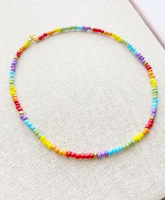 Seed Bead Choker Necklace 17 inches total length Perfect for layering with your favorites Glass Beads with Gold plated lobster clasp closure These little seed beads are 4mm wide A short extender tail will be added so you can adjust the length a little if you like Rainbow Round Bead Adjustable Necklace, Adjustable Rainbow Round Bead Necklaces, Multicolor Charm Necklaces With Round Beads, Multicolor Round Beads Choker With Lobster Clasp, Trendy Rainbow Necklaces With Tiny Beads, Colorful Adjustable Necklace With Tiny Beads, Colorful Adjustable Tiny Bead Necklaces, Adjustable Rainbow Necklaces With Spacer Beads, Rainbow Beaded Choker Necklace For Gift