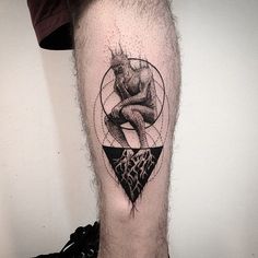 a man's leg with a black and white tattoo on it