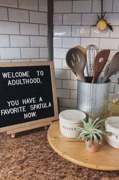 a sign that says welcome to adulthood you have a favorite spatula now