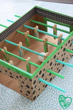 a close up of a box with clothes pins and pegs in it on a table