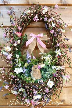 a wreath with flowers and a bunny on it