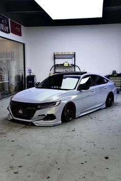 a silver car parked in front of a garage