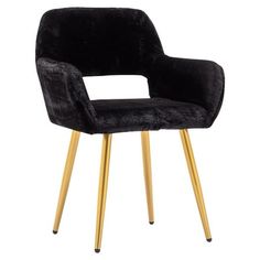 a black velvet chair with gold legs