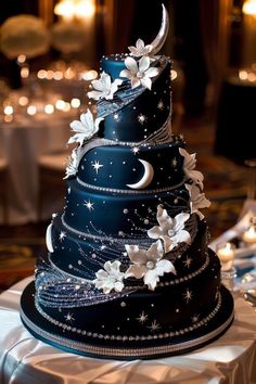 a three tiered cake decorated with stars and moon