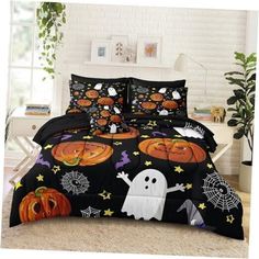 a bed covered in black and white halloween themed comforter sets with pumpkins, jack - o'- lanternes and web