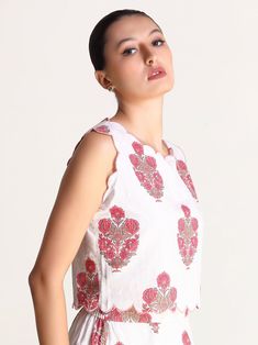 Featuring a scallop embroidery detailing, this one-of-a-kind motif print top is a piece of art that can’t be duplicated. Meticulously crafted from cotton and lined with mulmul, this top feels like second skin — incredibly soft and breathable! You won’t be able to resist falling head over heels for this gorgeous sleeveless top, which is the epitome of elegance. Rock it with the Magnolia Motif Print Skirt & with some chunky jewellery and sassy footwear while the print celebrates the real you! Mate Scallop Embroidery, Chunky Jewellery, Porcelain Print, Embroidery Detailing, Floral Print Skirt, Head Over Heels, Print Skirt, Tiered Dress, Matching Dresses