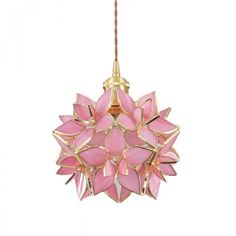 a pink and gold light hanging from a ceiling