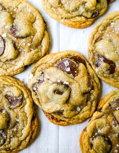 chocolate chip cookies are arranged on a table