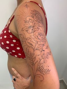 a woman with a flower tattoo on her arm