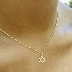 Add some faith and style to your everyday look with our Tiny Jewish Star of David Necklace! This delicate necklace features a tiny Star of David pendant, perfect for showing off your Jewish heritage in a subtle and fashionable way. You'll love adding this unique and meaningful piece to your jewelry collection! * Sterling silver * 1/4" * 16" rolo chain with a 2" adjustable extender Jewish Necklace, Star Of David Necklace, Hand Chain Bracelet, Jewish Heritage, Starburst Necklace, Jewish Star, Star Of David Pendant, Hamsa Necklace, Tiny Star