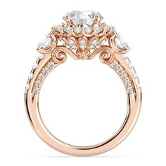 a rose gold engagement ring with diamonds on the side