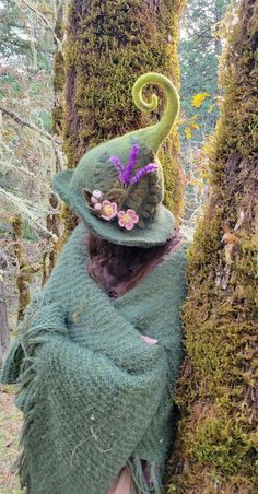 This hand-sculpted hat is made using almost 1lb of sheep's wool, making it extremely durable and able to hold its shape well, perfect for woodland walks.  Inspired by the blossoms of the apple trees growing wild on our land, it features three sprigs of lavender and three apple blossom flowers. We make our felted items using the ancient technique of wet felting. The process begins with raw sheep wool, which we buy locally from small family farms. We then wash dye and card the wool into batts, ready to sculpt and felt into whatever our imaginations dream up. Felted wool is considered to be among the world's oldest known textiles. It is both breathable and water-resistant, able to hold up to 40% of its own weight in water before it begins to feel wet. This makes it an excellent choice for bot Wool Felted Witch Hat, Handmade Whimsical Felt Hat For Winter, Whimsical Felt Hat With Curved Brim, Whimsical Handmade Wide Brim Felt Hat, Whimsical Wide Brim Handmade Felt Hat, Handmade Whimsical Wide Brim Felt Hat, Whimsical Handmade Felt Hat, Whimsical Handmade Felt Costume Hats And Headpieces, Handmade Whimsical Felt Hat