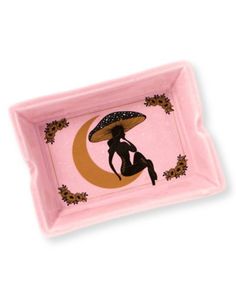 a pink tray with an image of a woman sitting on the moon holding an umbrella