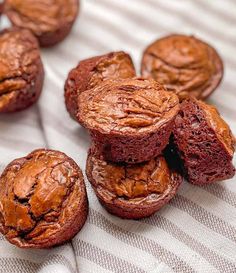 several chocolate muffins are stacked on top of each other