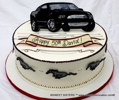 a birthday cake with a black car on top