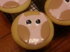 three decorated cookies sitting on top of a cooling rack