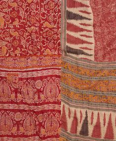 two red and one orange pieces of cloth with different designs on the sides, all together