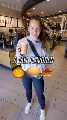 a woman holding a cup and a plate with a pumpkin on it