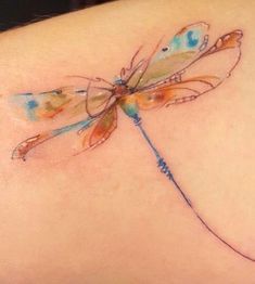 a woman's back tattoo with a dragonfly on her left side ribcage