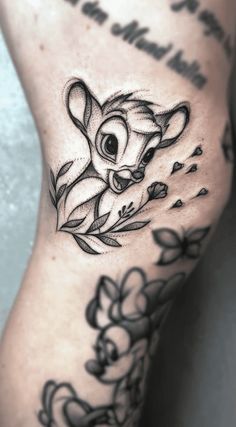 a black and white photo of a tattoo on the leg