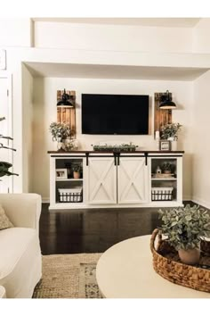 a living room filled with furniture and a flat screen tv mounted to the side of a wall