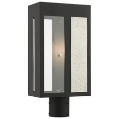 a light that is on the side of a pole with a glass panel in it