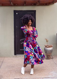 A stunning dress in a vibrant,  bold patchwork print in multi colours. It has statement puff sleeves, smocked at the top of the dress and fully lined in the skirt giving a flattering fit and flare silhouette. The    will take you through the seasons. In summer wear off shoulder with trainers or sandals and in cooler months wear with your favourite boots whatever the length and throw on your coat and scarf.  This statement swishy dress will be a favourite addition to your wardrobe. 100% cotton. H Multicolor Floral Print Knee-length Puff Sleeve Dress, Multicolor Floral Print Puff Sleeve Knee-length Dress, Multicolor Knee-length Puff Sleeve Dress With Floral Print, Multicolor Maxi Dress With Gathered Sleeves, Multicolor Midi Maxi Dress With Smocked Bodice, Multicolor Fitted Midi Puff Sleeve Dress, Multicolor Smocked Dress With Square Neck, Fitted Multicolor Puff Sleeve Midi Dress, Bohemian Multicolor Dresses With Gathered Sleeves