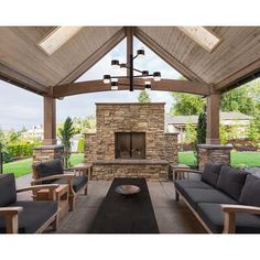 an outdoor living area with furniture and a fireplace