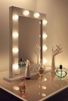 a lighted vanity mirror sitting on top of a table