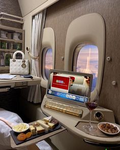 a laptop computer sitting on top of a tray filled with food