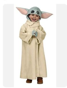 a child in a star wars yoda costume is standing with his hands together and smiling