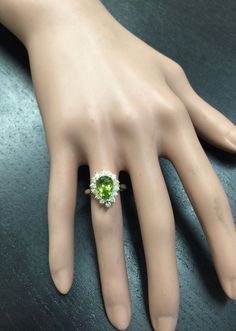 3.20 Carats Natural Very Nice Looking Peridot and Diamond 14K Solid Yellow Gold Ring Suggested Replacement Value: $5,300.00 Total Natural Pear Shaped Peridot Weight is: Approx. 2.50 Carats Peridot Measures: Approx. 11 x 7mm Natural Round Diamonds Weight: Approx. 0.70 Carats (color G-H / Clarity SI1-SI2) Ring total weight: 4.9 grams Ring total weight: Approx. 1.6 grams Disclaimer: all weights, measurements and colors are approximate and may vary slightly from the listed dimensions or as seen in t Formal Peridot Diamond Ring In Yellow Gold, Classic Multi-stone Green Gemstones, Classic Green Multi-stone Gemstones, Luxury Peridot Ring For Formal Occasions, Formal Peridot Diamond Ring With Center Stone, Elegant Multi-stone Peridot Gemstones, Green Multi-stone Diamond Ring For Formal Occasions, Luxury Peridot Jewelry With Accent Stones, Formal Green Multi-stone Diamond Ring