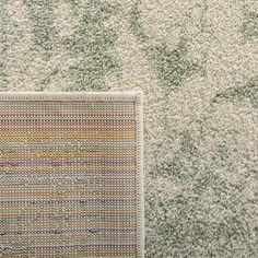 a close up view of a rug with different colors and patterns on it, including the carpet