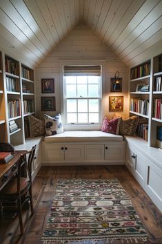 a room with some bookshelves and a rug on the floor