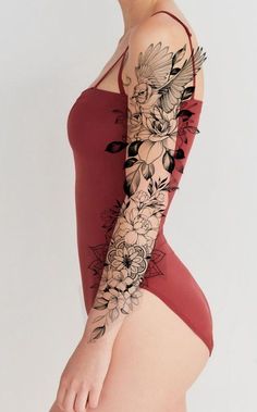 a woman in a red bodysuit with flowers on her arm