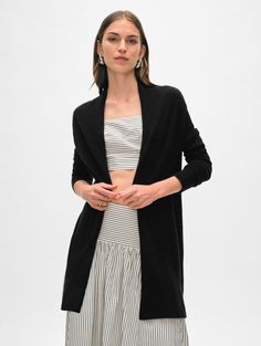 The longest-running piece at White + Warren, the Cashmere Trapeze Cardigan is a chic fingertip-length open sweater that works on every body type. No matter what color you choose, you'll want to wear this timeless style season after season. Details Straight fit. Long sleeve. Length in size small is 32.5" The model is 5'11" and wearing a size small. 100% Cashmere Hand wash cold or dry clean. Do not twist or wring. Reshape and lay flat to dry. Warm iron if needed. Style #11092 Chic Long Cashmere Cardigan, Black Cashmere Spring Outerwear, Spring Black Cashmere Outerwear, Black Cashmere Outerwear For Spring, Chic Black Open Front Sweater Coat, Chic Black Cashmere Cardigan, Versatile Black Cardigan For Daywear, Fitted Open Front Sweater Coat For Layering, Cashmere Travel Wrap