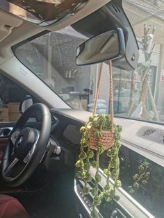 the interior of a car with plants hanging from it