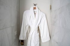 a bathrobe hanging on the wall in a bathroom