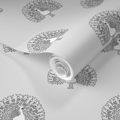 a white wallpaper with silver peacocks on it