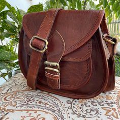 VISIT MY SHOP FOR MORE LEATHER ITEM LINK BELOW https://www.etsy.com/in-en/shop/HandmadeCYKarigar/edit?ref=seller-platform-mcnav Expedited Shipping ,Fast Shipping , Fast delivery  PLEASE PROVIDE YOUR PHONE NUMBER FOR FAST AND BETTER DELIVERY The Bag is 100% handmade from genuine unprocessed leather and is tanned using traditional Sun tanning process and vegetable oils. No chemicals are used during the making of this bag Simple design, useful and very comfortable, designed for use at all times, a Handmade Saddle Shoulder Bag For Travel, Handmade Saddle Bag For Everyday Use, Vintage Leather Saddle Bag With Mobile Phone Pocket, Brown Waxed Finish Shoulder Bag Satchel, Dark Tan Leather-lined Satchel Shoulder Bag, Brown Waxed Shoulder Satchel, Hand-tooled Brown Crossbody Satchel, Retro Brown Hand-tooled Satchel, Sun Tanning