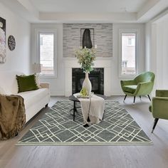 a living room filled with furniture and a fire place in the middle of the room