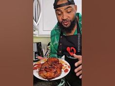 a man in an apron holding a plate of food