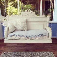 a white swing bed sitting on top of a wooden floor