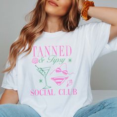 Join the club with our Tanned And Tipsy Social Club Tee. Made for those who don't take themselves too seriously, this tee will add a touch of fun to your wardrobe. Get ready to make new friends and have a great time with this quirky and playful shirt. Design is Printed Direct to Garment. See Size Guide for Comfort Color Unisex Tee We recommend comparing these measurements against a shirt that you like the fit of for ordering a tee that will fit best. Crafted Just for You: Our products are made to order, and we're all about delivering that extra touch of personalization. Expect an order confirmation email right after you shop, and then we'll hustle to get your order ready within 7 days. When it's time to ship, we'll send you a delightfully exciting email with tracking to keep you in the loo Trendy Vacation Tops For Day Out, Trendy Tops For Vacation Day Out, Beachy Tops With Funny Print For Spring, Beachy Spring Tops With Funny Print, Spring Graphic Tee For Beach Party, Trendy Relaxed Fit T-shirt For Beach Party, Spring Letter Print Tops For Beach Party, Trendy Vacation Tops With Funny Print, Trendy Tops With Funny Print For Vacation