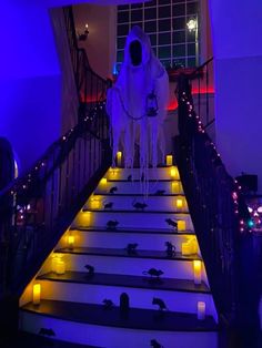 a stairway decorated with candles and fake ghost on it's side for halloween decorations