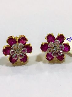 Inspired by the fantastic variety of shapes and colors, these earrings offers a surprising and charming balance between the gold structure of the ring and the delicacy of the carefully selected rubies & rose cut diamonds. The result is a harmonic and sophisticated earrings with a unique character and having an in-built interchangeable feature where you can remove the center rose cut diamond section and replace it with anything of your choice :) The gemstones are firmly set, and connected to Elegant Multicolor Diamond Earrings, Exquisite Diamond Flower Shaped Earrings, Exquisite Diamond Flower-shaped Earrings, Hand Set Yellow Gold Fusion Earrings, Fusion Style Hand Set Yellow Gold Earrings, Party Yellow Gold Hand Set Earrings, Party Hand Set Yellow Gold Earrings, Luxury Gemstone Flower-shaped Earrings, Luxury Flower Shaped Cluster Earrings For Wedding