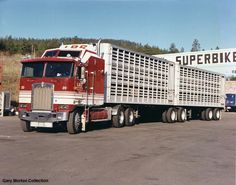 a red and white semi truck parked in a parking lot