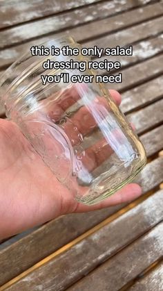 a person holding a glass jar in their hand